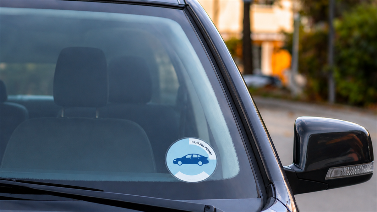 Parking permit sticker on a vehicle windshield