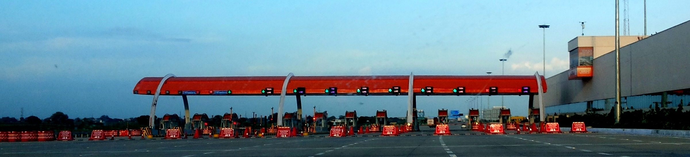 Yamuna Expressway toll plaza with multiple lanes and booths visible